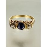 A Russian gold 583 stamped three stone ring set sapphire and diamonds, the oval sapphire