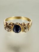 A Russian gold 583 stamped three stone ring set sapphire and diamonds, the oval sapphire