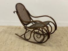 A vintage bentwood rocking chair, mid 20th century, of scrolling form, with bergere seat and back