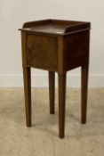 A 19th century mahogany bedside cabinet, with galleried top over one door opening to a plain