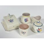 A Poole pottery butter dish and cover in the Art Deco style with hand painted floral sprays and