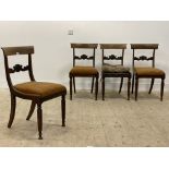 A set of four late Regency rosewood dining chairs, each with curved crest rail and floral carved bar