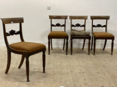 A set of four late Regency rosewood dining chairs, each with curved crest rail and floral carved bar