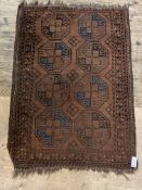 An antique bokhara rug, the dark red field with six gul motif and bordered. 93cm x 140cm.