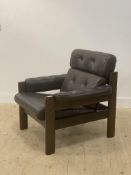 Ekornes, a 1970's 'Amigo' armchair, upholstered in buttoned brown leather on a stained hardwood