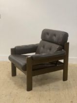 Ekornes, a 1970's 'Amigo' armchair, upholstered in buttoned brown leather on a stained hardwood