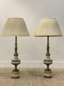 A large pair of gilt brass table lamps complete with white shades. H100cm.