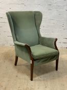 Parker Knoll, a mid century armchair, upholstered in green velour, raised on tapered supports.