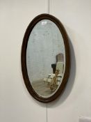 An early to mid 20th century oak framed wall hanging mirror with bevelled plate 62cm x 40cm.