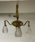 An Edwardian cast gilt brass ceiling light fitting, the three cut glass shades on scrolling branches