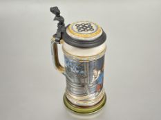 A German Mettlach stoneware beer stein with pewter mounted hinged cover and incised figures