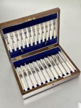 Edwardian oak Walker & Hall canteen containing a set of twelve pairs of Epns mother of pearl handled