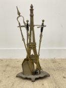 A late 19th century cast brass fire companion set, comprised of a stand taking the form of the