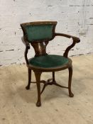 An Edwardian mahogany desk chair, the crest rail and splat inlaid with boxwood paterae, green