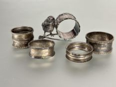 A collection of four various Birmingham silver napkin rings 77.6g and an Epns Best Wishes novelty
