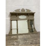 A late Victorian floral carved and sectional over mantel mirror with open shelves and painted in