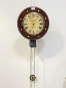 A 19th century wag on the wall clock, the circular mahogany case with mother of pearl inlay