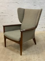 Parker Knoll, a mid century upholstered wingback armchair, raised on tapered supports. H94cm,