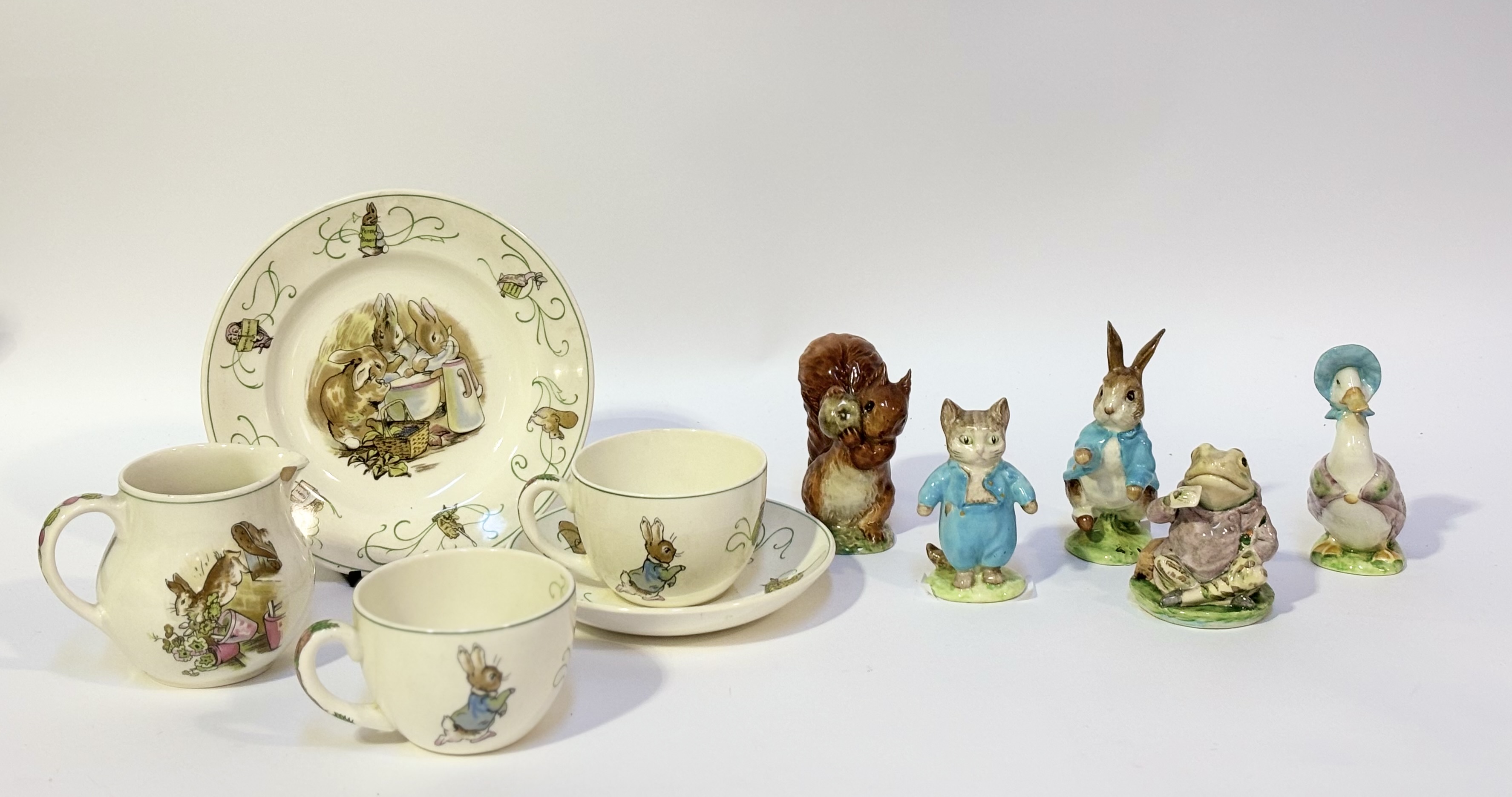 A Wedgwood Barlaston Peter Rabbit pattern part tea service comprising two teacups, a saucer, a plate