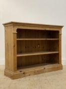 A pine floor standing open bookcase, fitted with two adjustable shelves, flanked by reeded pilasters