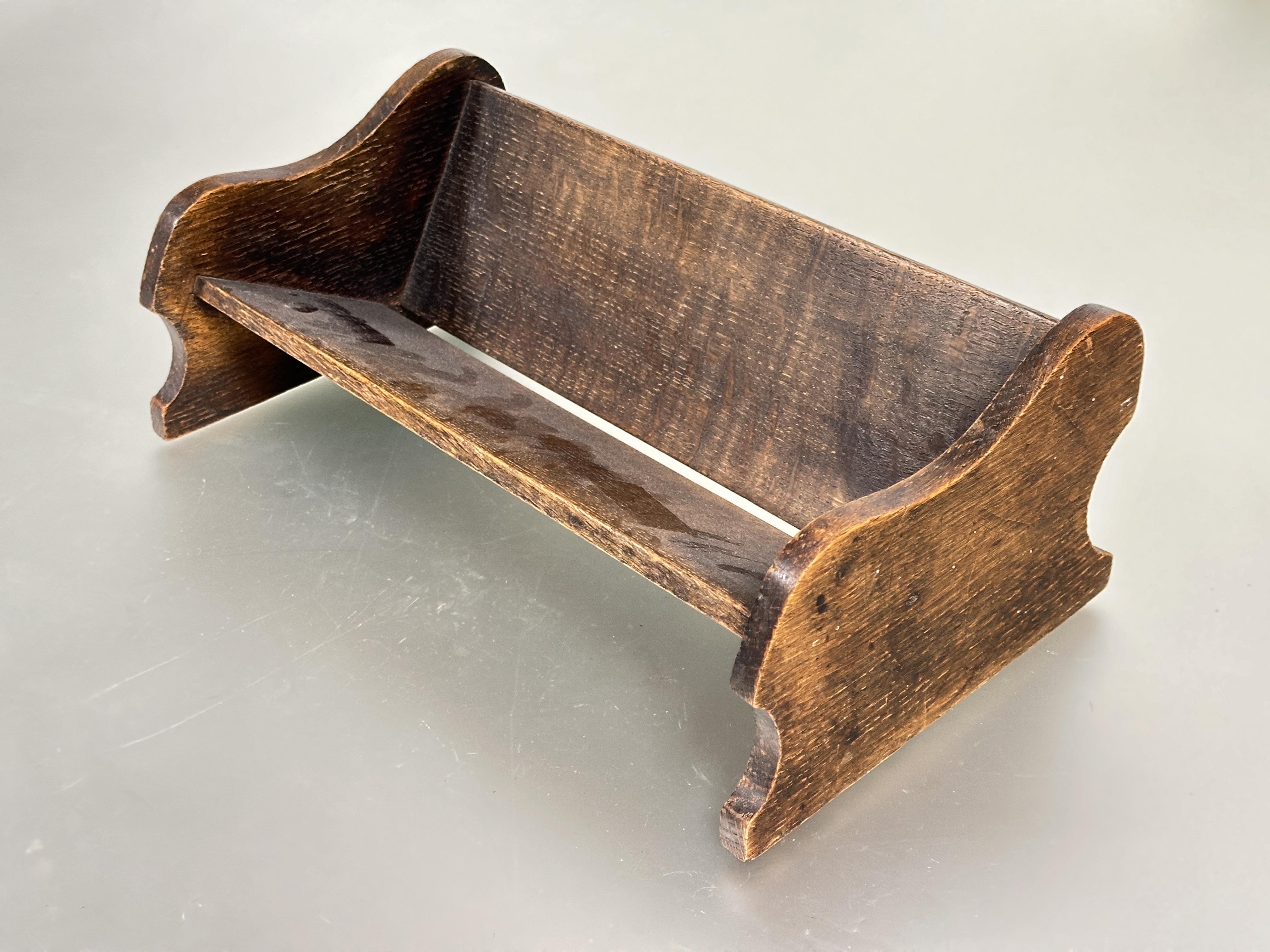 A 1920s -30s oak book trough with shaped sides H x 13cm L x 36 cm