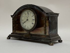 An early 20th century silver plated dome top mantel clock, the case with trailing bow ribbon hare