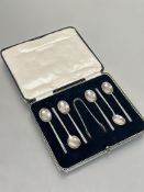 A boxed set of six Sheffield silver plain handled coffee spoons with pair of matching tongs  L x 8.