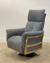 Ercol, a contemporary 'Ginosa' swivel and reclining armchair, covered in grey / blue fabric,