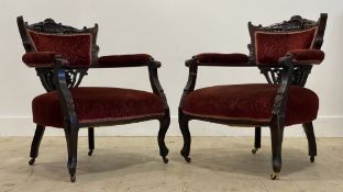 A pair of Victorian walnut framed tub drawing room chairs, with shell and floral carved crest