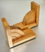 A pair of pine Art Deco style bookends with arched panels mounted on rectangular ends with felted