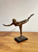 A modern bronzed finish resin sculpture of a figure in ballet pose raised on base H x 31cm L x 44