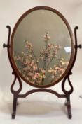 A 19th century mahogany Vanity mirror, the oval plate with ebonised string inlay rotating between