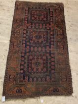 An antique  Turkmen baluch rug of typical design and bordered 203cm x 110cm.