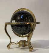 A modern Celestial globe, rotating on a twin axis and standing on a chrome plated tripod base