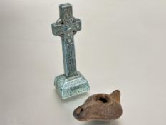 A porcelain Iona St Martins cross with sage glaze H x 16cm and a Roman terracotta pottery oil lamp