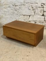 A mid century teak low unit fitted with a single drawer. H36cm, W85cm, D55cm.