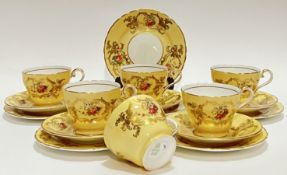A set of six Aynsley Bone China tea cup trios (missing one saucer), decorated with floral sprays wit