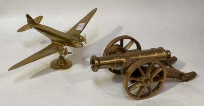 An early 20th century cast brass model of a twin propeller aeroplane (L27cm), together with a