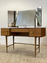 A mid century teak dressing table, fitted with triptych swing mirror above one long and three