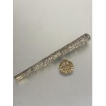 An Eastern white metal tapered cylinder parasol handle with five chased panels depicting boars,