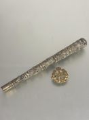 An Eastern white metal tapered cylinder parasol handle with five chased panels depicting boars,