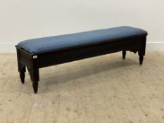 A late 19th century oak bench, with blue linen covered drop in seat pad above a lunette carved