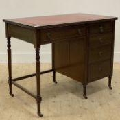 An Edwardian mahogany writing desk, the top inset with tooled red leather writing surface above