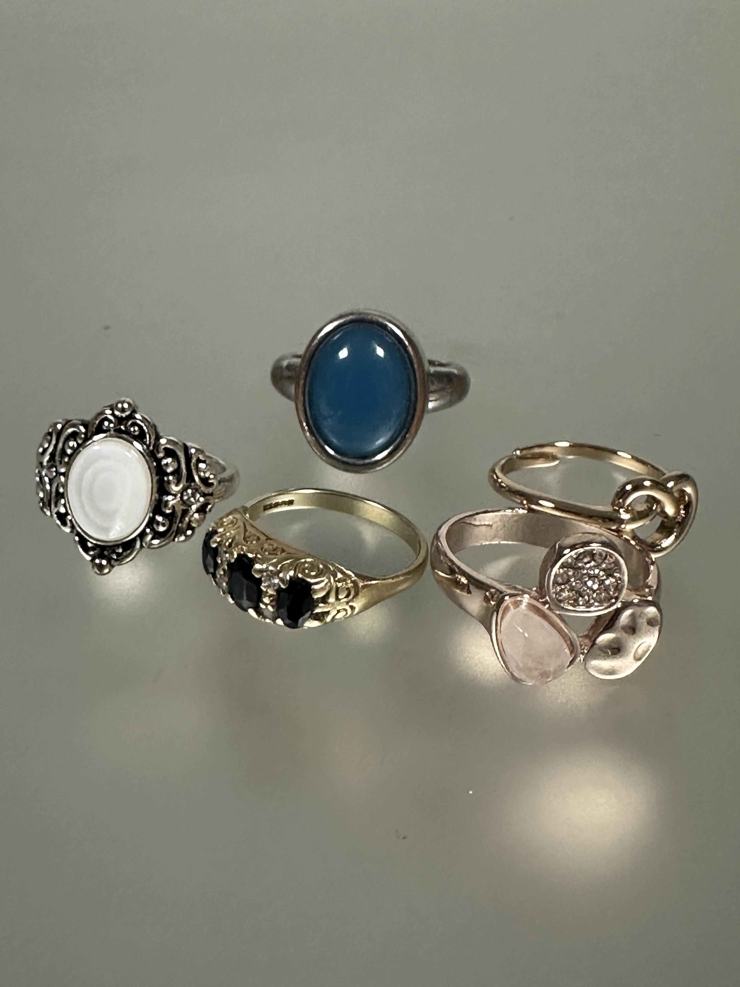 A collection of four various white and yellow metal dress rings and a 9ct gold three stone graduated