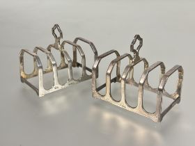 A pair of Birmingham silver four division breakfast toast racks of rectangular form, show no signs