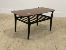 A mid century teak coffee table, circa 1960's, the shaped rectangular top above a slatted under tier