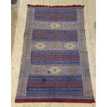 A North African / Moroccan flat weave rug, the blue field of lineal design with three panels