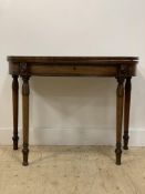 A late Regency mahogany demi-lune tea table, the fold over and cross banded top above an ebony