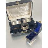 A boxed set of two Edwardian Birmingham silver navette shaped engine turned napkin rings L x 6.5cm