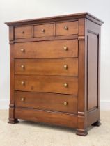 A traditional cherry wood chest, fitted with three short and four long drawers, panelled sides and